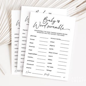 May include: Three white baby shower game cards with the text "Baby Word Scramble" in elegant script. The cards feature scrambled words and lines for answers, perfect for a baby shower activity. The background is a soft, neutral color.