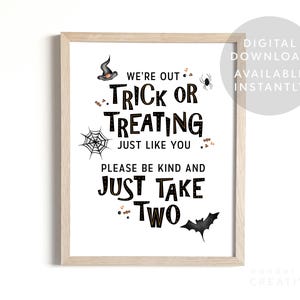 May include: A framed Halloween-themed sign with the text "We're Out Trick or Treating Just Like You, Please Be Kind and Just Take Two." The sign includes illustrations of a witch's hat, spider, spiderweb, candy, and a bat. The words are in black.
