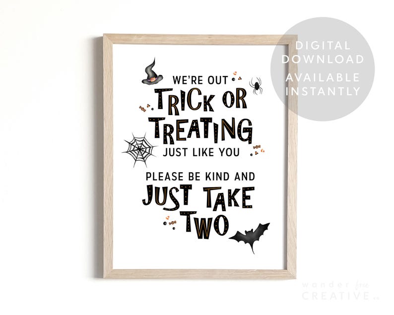 May include: A framed Halloween-themed sign with the text "We're Out Trick or Treating Just Like You, Please Be Kind and Just Take Two." The sign includes illustrations of a witch's hat, spider, spiderweb, candy, and a bat. The words are in black.