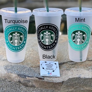 May include: Three reusable plastic cups with lids and straws. The cups are turquoise, black, and mint green. Each cup has a black and white design with the text "Officially Adulting Eighteen" and a stylized image of a mermaid.