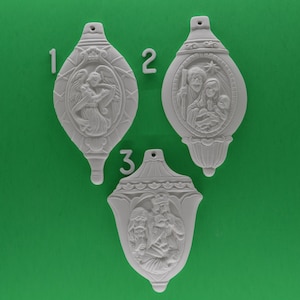 May include: Three white ceramic Christmas ornaments with raised relief designs. The ornaments depict a religious theme with an angel, the Holy Family, and the three wise men.