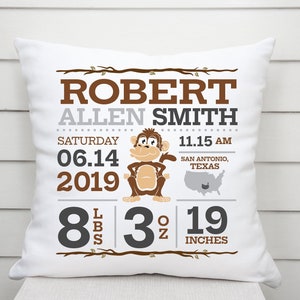 May include: A white pillow with a brown and grey design featuring a monkey, the name "Robert Allen Smith", the date "06.14.2019", the time "11.15 AM", the location "San Antonio, Texas", and the baby's weight and length: 8 lbs 3 oz 19 inches.