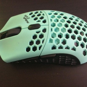 May include: A light blue gaming mouse with a honeycomb design and the text "Glorious Model O" printed on the side.