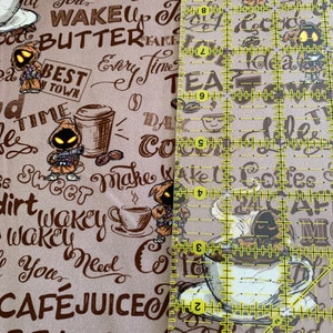 May include: A brown and beige fabric with a coffee theme. The fabric features a repeating pattern of coffee cups, coffee beans, and text that says "Cafe Life", "Wake Up Jacob", "Butter", "Best in Town", "Take Every Time", "Be Sweet", "Make Coffee", "Dirt Wakey", "Wakey", "You Need Coffee", "Cafe Juice", "Beans", "Take Every Time".