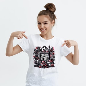 May include: White t-shirt with a black and red graphic design of a gothic archway with books and roses. The text on the graphic says "Good Girls Read Bad Books."