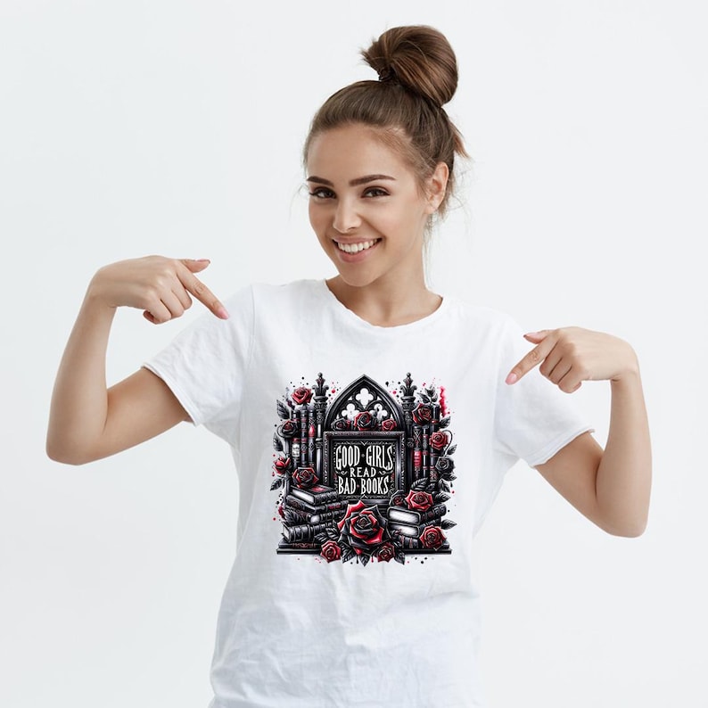 May include: White t-shirt with a black and red graphic design of a gothic archway with books and roses. The text on the graphic says "Good Girls Read Bad Books."