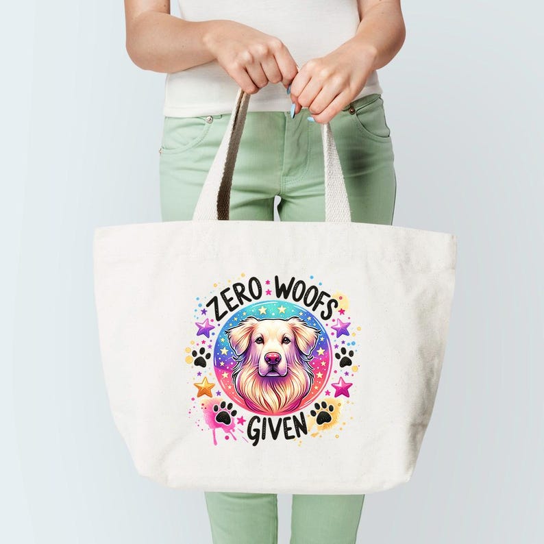 May include: White canvas tote bag with a colorful graphic of a dog's head and the text "ZERO WOOFS GIVEN".