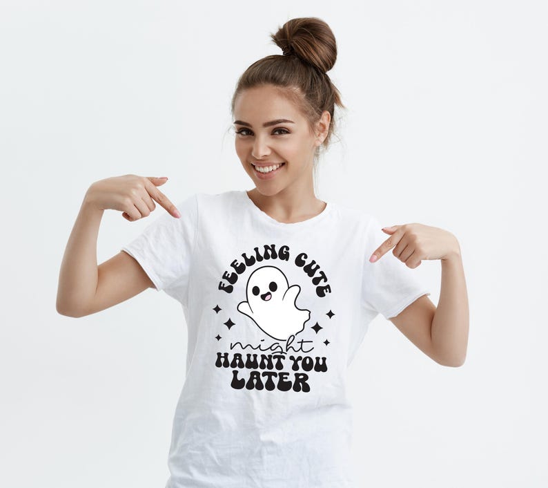 May include: White t-shirt with a black and white graphic of a ghost with the text "Feeling Cute Might Haunt You Later".