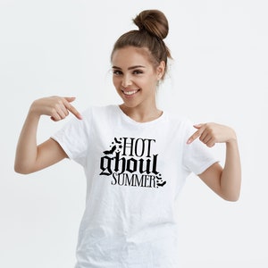 May include: White t-shirt with a black graphic that says "HOT ghoul SUMMER" with bats around the text.