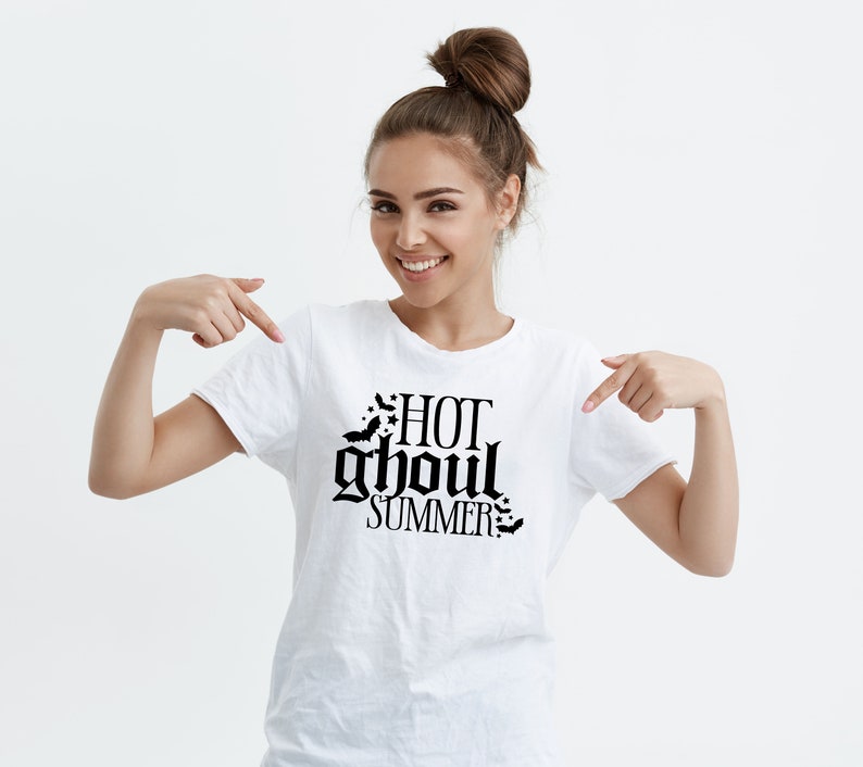 May include: White t-shirt with a black graphic that says "HOT ghoul SUMMER" with bats around the text.