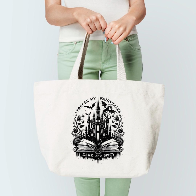 May include: A white canvas tote bag with a black graphic design featuring a castle, a dragon, and the text "I prefer my fairytales dark and spicy".