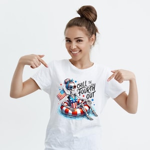 May include: White t-shirt with a graphic of a skeleton wearing a red, white, and blue swimsuit and holding an American flag. The skeleton is sitting in a red, white, and blue inflatable ring. The text "Chill the Fourth Out" is printed on the shirt.