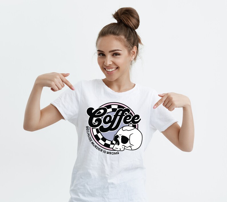 May include: White t-shirt with a black and white graphic design of a skull and the text "Coffee because murder is wrong".