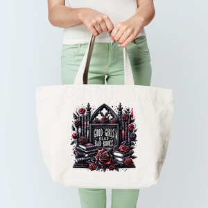 May include: A white tote bag with a black and red graphic design. The graphic features a gothic archway with books and roses. The text on the graphic reads "Good Girls Read Bad Books".