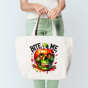 May include: A white tote bag featuring a red, green and yellow apple with a skull face and the text "Bite Me" printed on it.