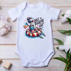 May include: White baby onesie with a skeleton wearing a red, white, and blue swimsuit and a life preserver. The skeleton is holding an American flag. The text on the onesie says "Chill the Fourth Out".