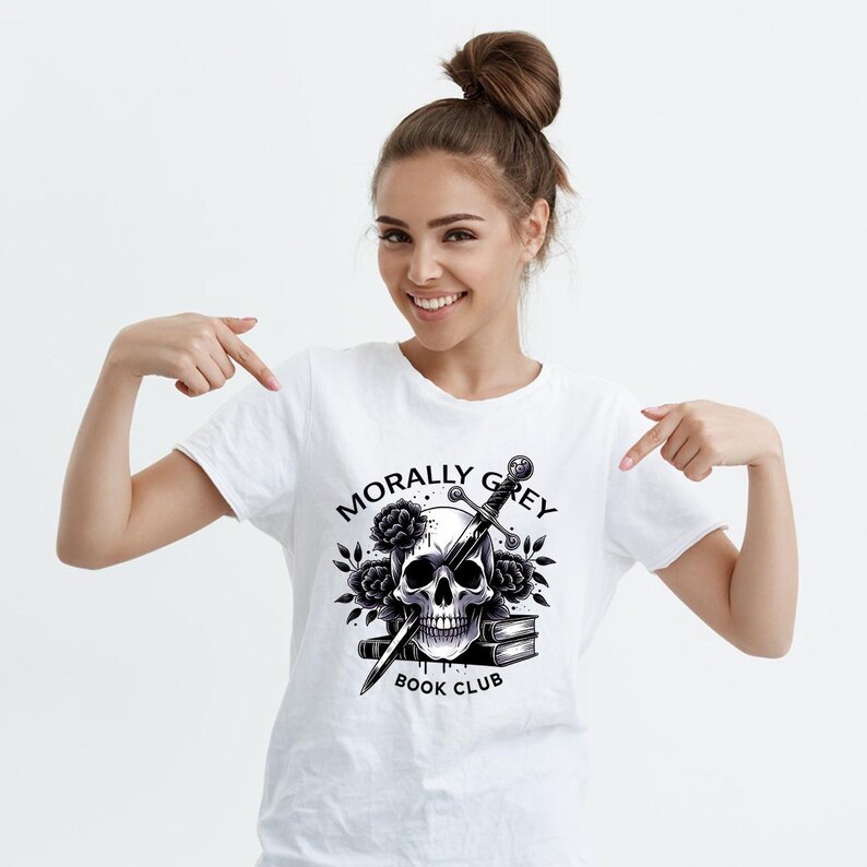 May include: White t-shirt with a black and white graphic design of a skull with a sword through it and the text "Morally Grey Book Club".