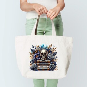 May include: A white tote bag with a skull and floral design. The skull is surrounded by blue and purple flowers and leaves. The text "Morally Grey Book Club" is printed on the books below the skull.