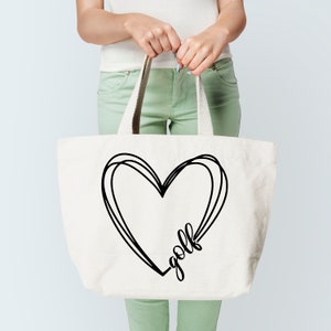 May include: A white canvas tote bag with black handles and a black graphic of a heart with the word "golf" inside.