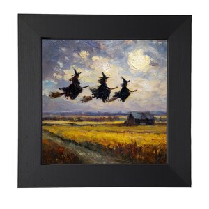 May include: A square black frame containing an oil painting of three figures in dark pointed hats riding broomsticks across a cloudy sky above a yellow field and a small dark building. The brushwork is visible and textured throughout the scene.