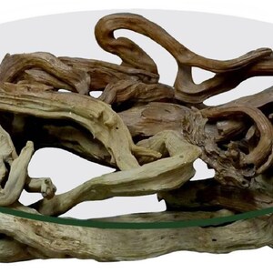 May include: A round glass top coffee table with a unique base made of natural driftwood branches. The branches are intertwined and create a rustic and organic look.