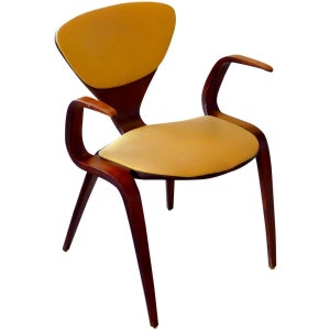 May include: A mid-century modern armchair with a yellow upholstered seat and back, and wooden arms and legs.