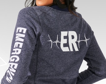 May include: A navy blue sweatshirt with white text on the sleeves that reads "EMERGENCY" and white text on the back that reads "ER" with a heartbeat graphic.