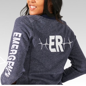 May include: A navy blue sweatshirt with white text on the sleeves that reads "EMERGENCY" and white text on the back that reads "ER" with a heartbeat graphic.
