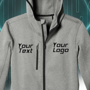 Puede incluir: Una sudadera con capucha gris con ribetes negros y una cremallera negra. La sudadera tiene una capucha con cord&oacute;n. El texto "Your Text" y "Your Logo" est&aacute; impreso en la parte delantera de la sudadera.