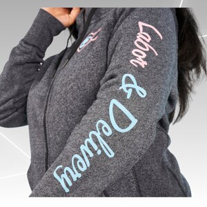 May include: Gray zippered hoodie with the text "Mama & Dada" in blue and "Love you" in pink on the sleeves.