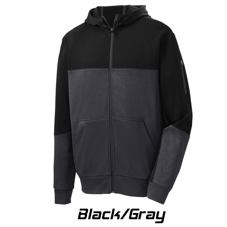 May include: Black and gray hooded sweatshirt with a zipper closure. The sweatshirt has a contrasting color panel on the lower body and sleeves.