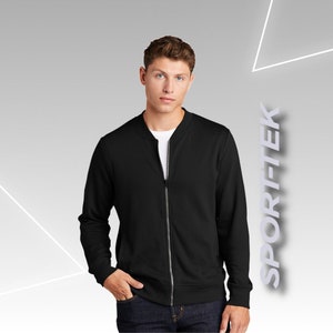 May include: A black zippered bomber jacket with a ribbed collar and cuffs. The jacket is made of a soft, comfortable fabric.