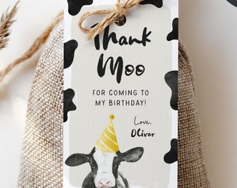May include: A black and white cow with a yellow party hat on its head. The cow is on a thank you tag with the text "Thank Moo" and "For coming to my birthday! Love, Oliver". The tag is attached to a small burlap bag.
