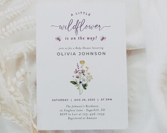 May include: A baby shower invitation featuring a watercolour illustration of wildflowers. The invitation reads "A Little Wildflower is on the way!" and includes the name Olivia Johnson, the date and time of the shower, and the location. The invitation also includes the RSVP information and the registry information.