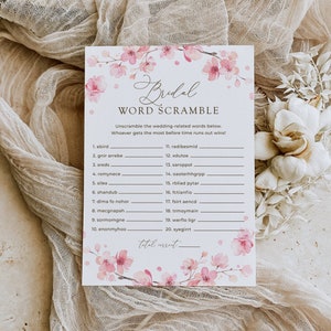 May include: A printable bridal shower game with a pink floral design. The game is called "Bridal Word Scramble" and asks players to unscramble wedding-related words.