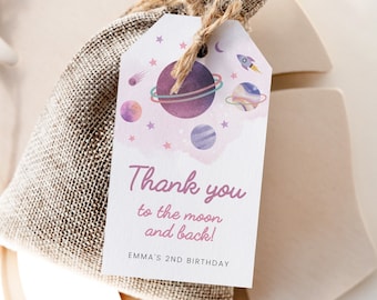May include: A small burlap gift bag with a tag featuring a watercolor design of planets, stars, and a rocket ship. The tag reads "Thank you to the moon and back!" and "EMMA'S 2ND BIRTHDAY". The bag is tied with twine.