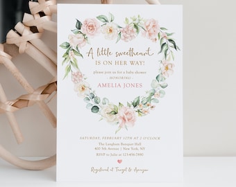 May include: Baby shower invitation with floral heart wreath. The invitation reads "A little sweetheart is on her way!" in gold script. The invitation includes the honoree's name, Amelia Jones, and event details.
