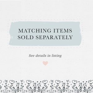 May include: A light blue background with a white border and the text "MATCHING ITEMS SOLD SEPARATELY" in black. Below the text is the phrase "See details in listing" in black. A small pink heart is below the text. A border of black floral designs with small hearts is at the bottom of the image.