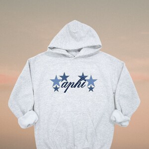 May include: A gray hooded sweatshirt with a blue and white star design and the word "aphi" in cursive.