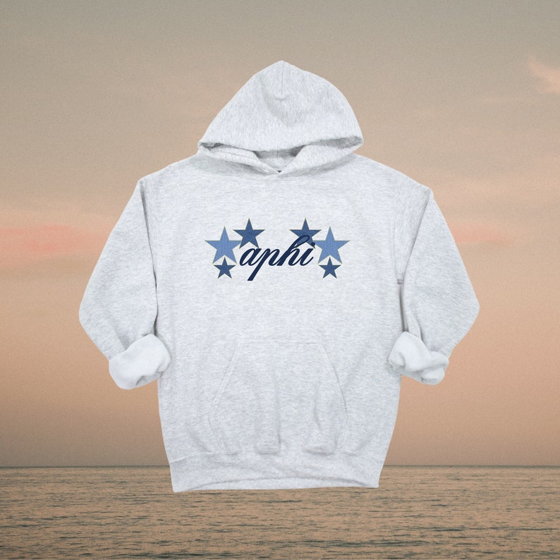 May include: A gray hooded sweatshirt with a blue and white star design and the word "aphi" in cursive.