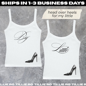 May include: Two white tank tops with black text and high heel shoe graphics. One top says "Big" and the other says "Little". The phrase "head over heels for my little" is above the second tank top.