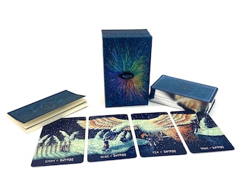 May include: A tarot card deck with a dark blue box featuring a colorful eye design. The deck includes a booklet and several cards with illustrations and text, including "Eight of Swords," "Nine of Swords," "Ten of Swords," and "Page of Swords."