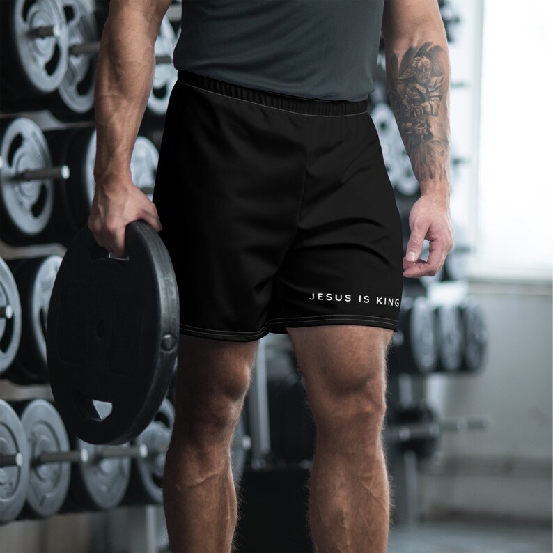 May include: Black athletic shorts with the text "JESUS IS KING" in white lettering.