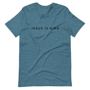 May include: A teal blue t-shirt with the text "JESUS IS KING" printed in black.