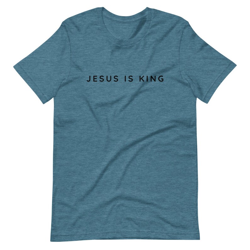 May include: A teal blue t-shirt with the text "JESUS IS KING" printed in black.