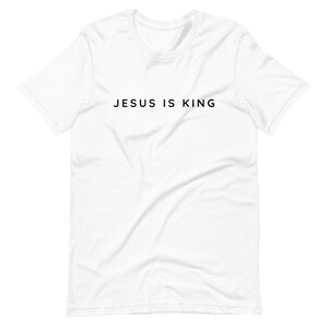 May include: White t-shirt with black text that reads "JESUS IS KING".