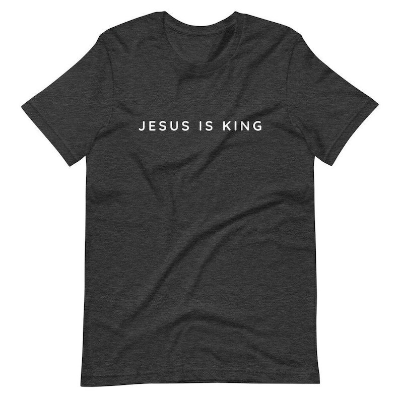 May include: A dark heather grey t-shirt with the text "JESUS IS KING" printed in white on the front.