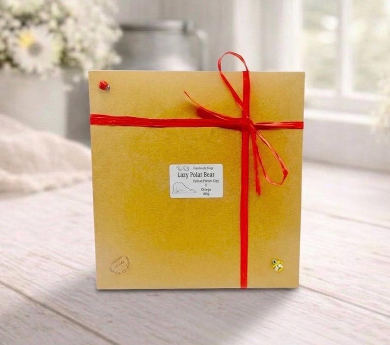 huge highly detailed polar bear shaped vegan bar soap, handmade and resting on a rustic wooden table with floral backdrop - ideal sustainable gift idea for animal lovers.