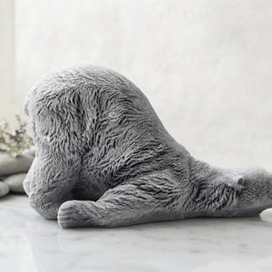 huge highly detailed polar bear shaped vegan bar soap, handmade and resting on a rustic wooden table with floral backdrop - ideal sustainable gift idea for animal lovers.