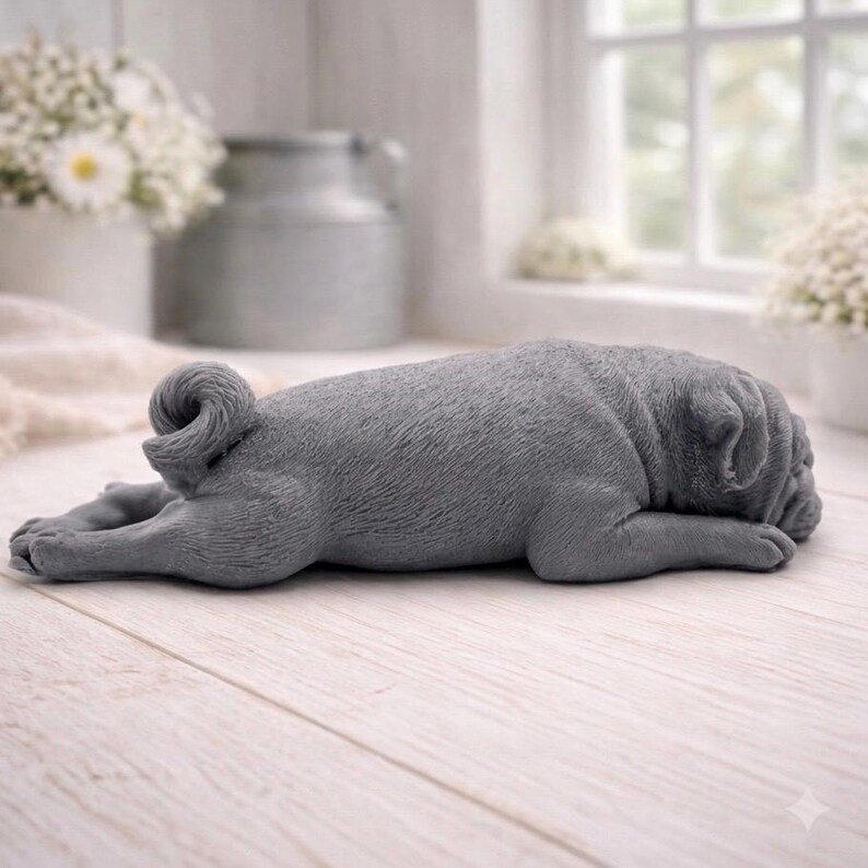 A detailed handmade vegan soap gift, sculpted in the shape of a pug dog lying flat on its stomach in a sleeping position, showing realistic skin folds and fur texture